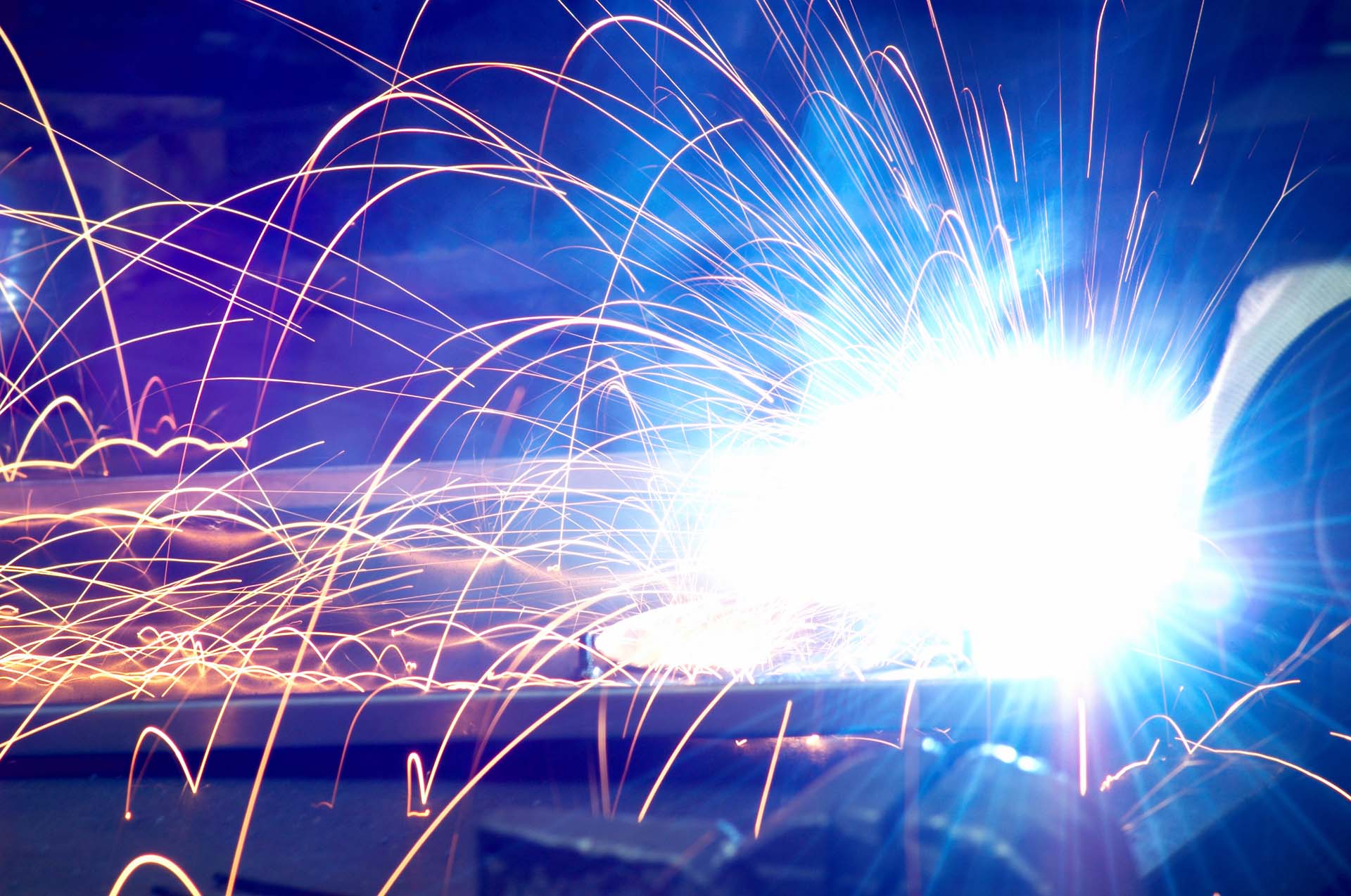 Close-up of bright light from welding with orange sparks